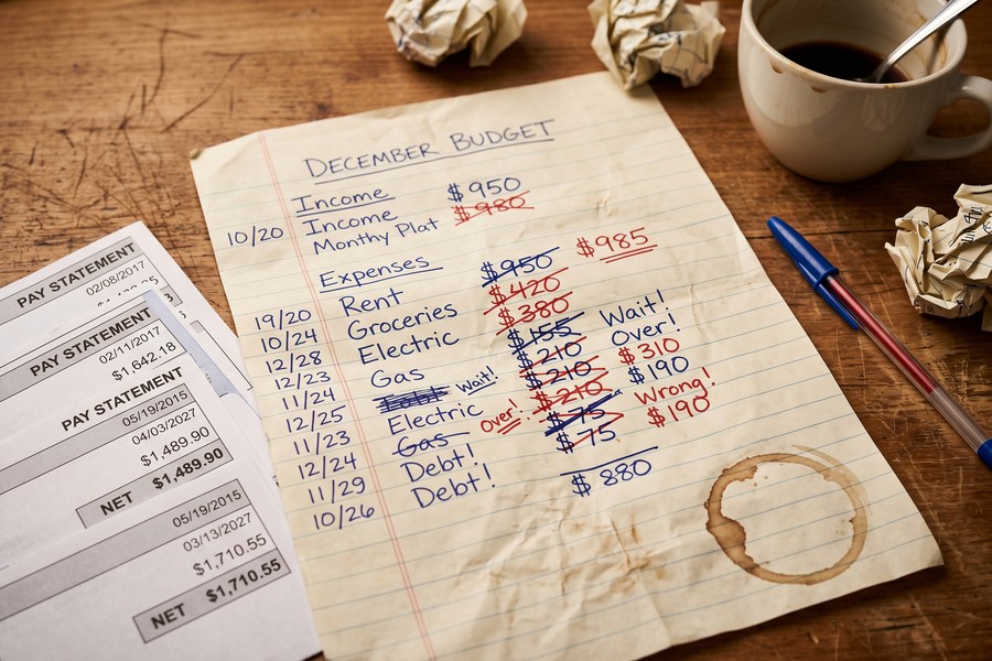 Nurse reviewing complex pay stub showing base pay, differentials, and overtime at a hospital break room