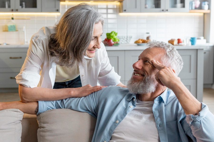 Older couple reviewing floor plans for downsized home