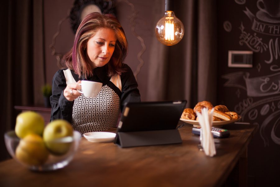 A high‑income earner staring at a shrinking bank balance on a smartphone while luxury purchase notifications stack up